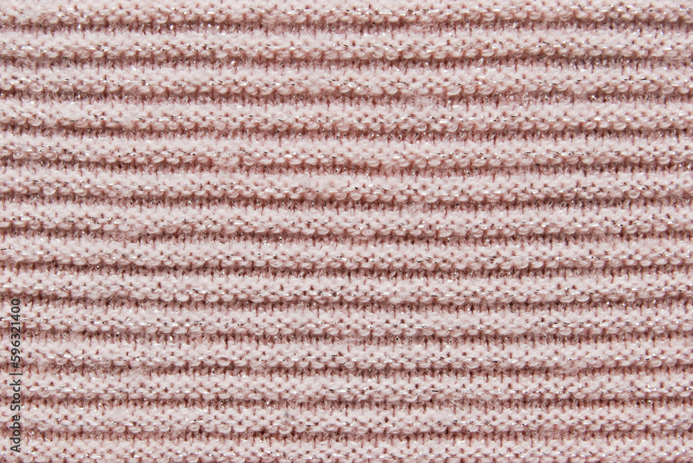 Ribbed light pink soft jersey fabric pattern texture with metallic threads as background
Ribbed light pink soft jersey fabric pattern texture with metallic threads as background