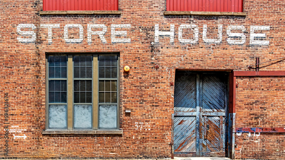Warehouse brick front background  with Store House stenciled above door