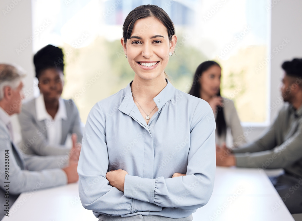 I know my worth and I can prove it. Portrait of a young businesswoman standing with her arms crossed in an office with her colleagues in the background. I know my worth and I can prove it. Portrait of a young businesswoman standing with her arms crossed in an office with her colleagues in the background.