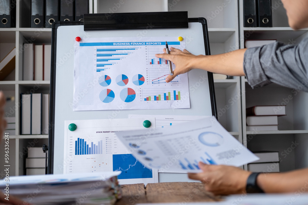 Closed up a business man present and point at chart of figure summary statistic, Business man presentation with flipchart Closed up a business man present and point at chart of figure summary statistic, Business man presentation with flipchart
