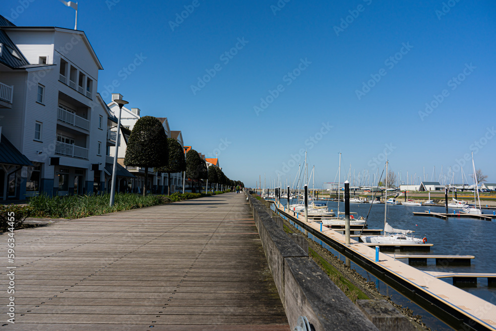 Walking route in Nieuwpoort along 1 of the largest marinas in Europe with a view of the North Sea and the harbour. There is a large wide renewed path for both cyclists and walkers. Walking route in Nieuwpoort along 1 of the largest marinas in Europe with a view of the North Sea and the harbour. There is a large wide renewed path for both cyclists and walkers.