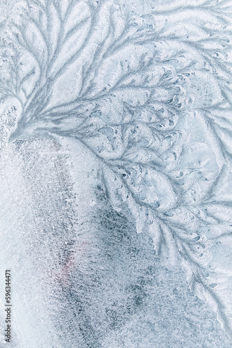 Abstract ice textures on car window in winter photo