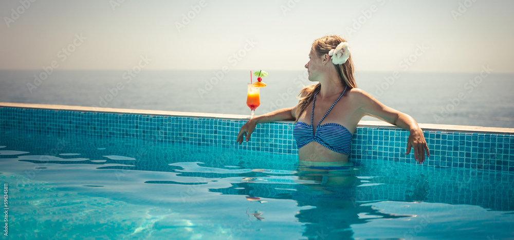 Fototapeta premium Woman relaxing at the pool