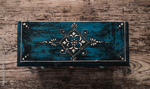 Ornamental box placed on wood background