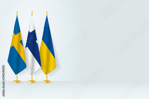 Flags of Sweden, Finland and Ukraine stand in row on indoor flagpole.