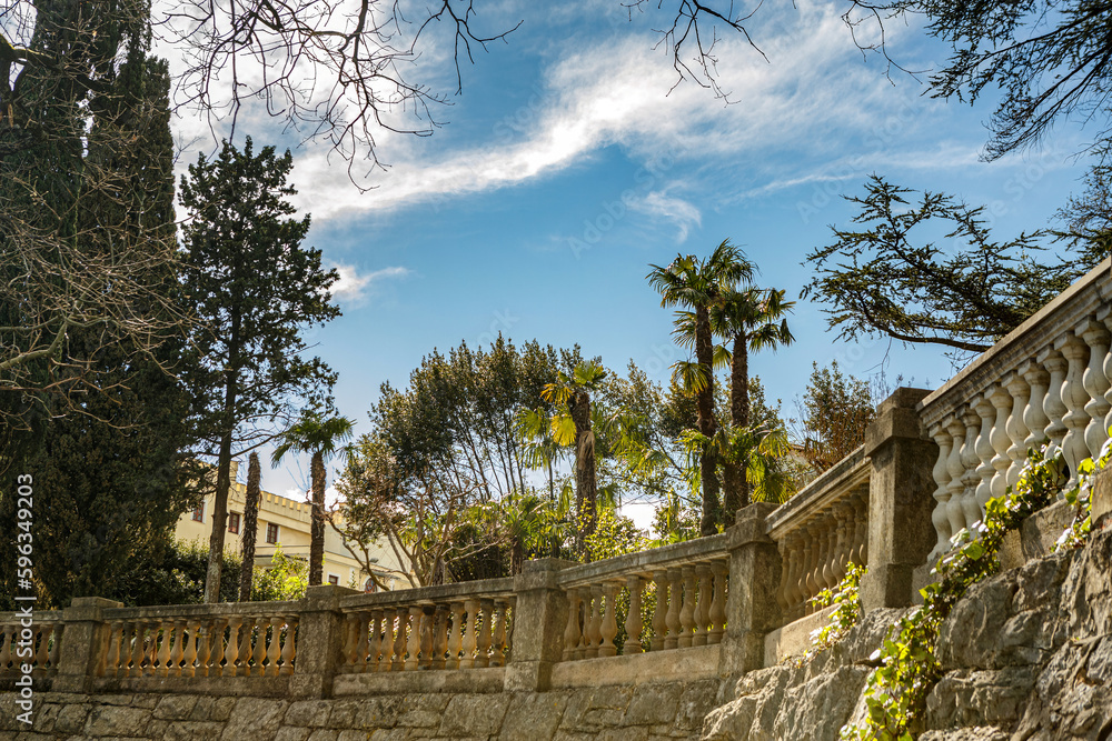 View at a mediterrean garden with palm trees along the promenade in Opatija, Istria, Croatia, in early spring outdoors