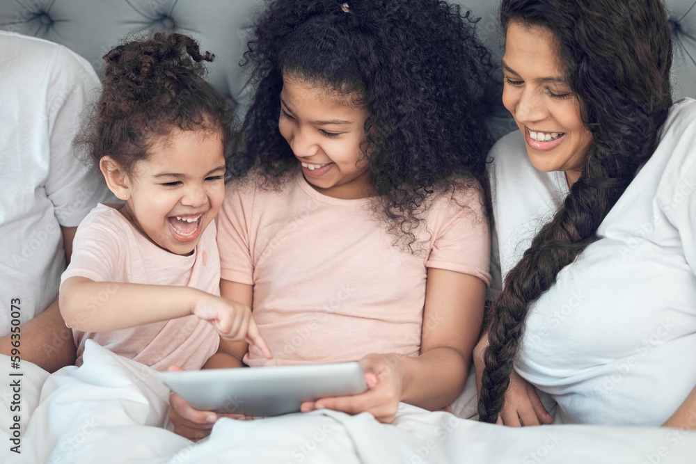 Our home is filled with laughter. Shot of a beautiful young family talking and bonding in bed together. Our home is filled with laughter. Shot of a beautiful young family talking and bonding in bed together.