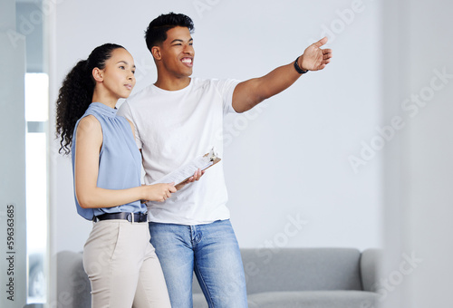 Youve got a great view here. Shot of a rental agent standing with his client and showing her the apartment.