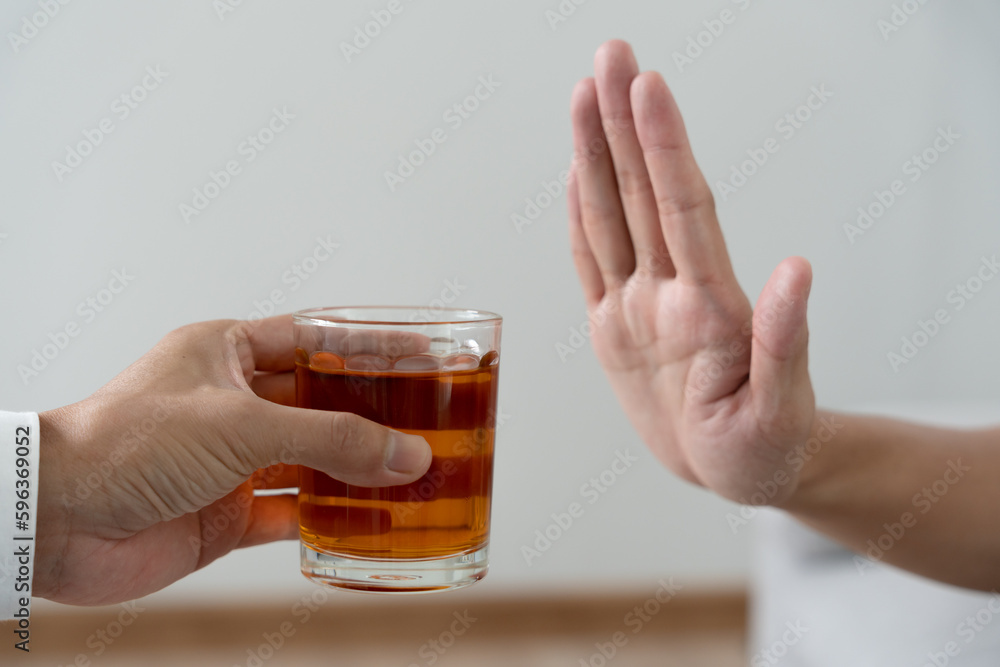 man refuses say no and avoid to drink an alcohol whiskey , stopping hand sign male, alcoholism treatment, alcohol addiction, quit booze, Stop Drinking Alcohol. Refuse Glass liquor, unhealthy, reject man refuses say no and avoid to drink an alcohol whiskey , stopping hand sign male, alcoholism treatment, alcohol addiction, quit booze, Stop Drinking Alcohol. Refuse Glass liquor, unhealthy, reject
