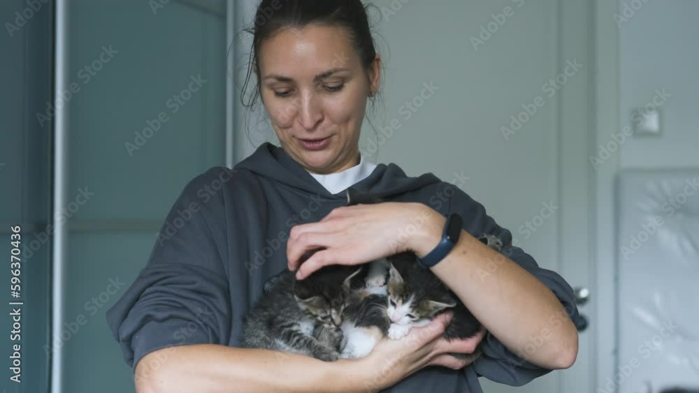 portrait of a woman holding a bunch of kittens portrait of a woman holding a bunch of kittens