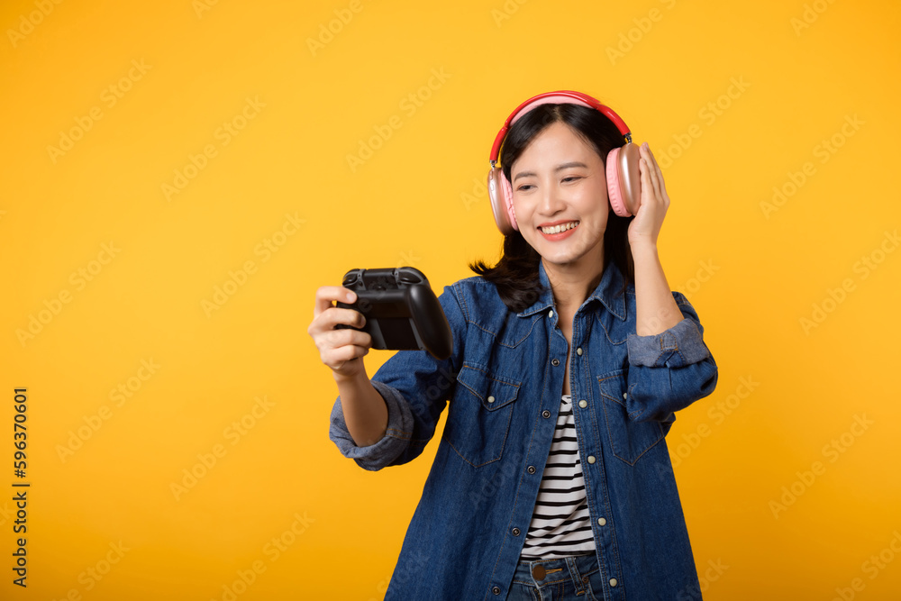 Portrait young asian woman with happy success smile wearing denim clothes holding joystick controller and playing video game. Fun and relax hobby entertainment lifestyle concept. Portrait young asian woman with happy success smile wearing denim clothes holding joystick controller and playing video game. Fun and relax hobby entertainment lifestyle concept.