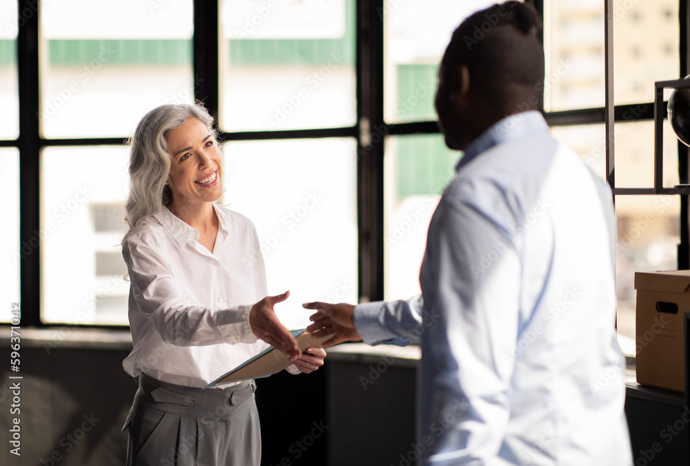 Fototapeta premium HR Manager Woman Shaking Hands With Job Applicant In Office