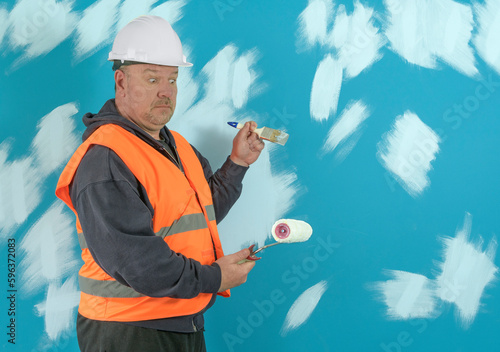 Painting a wall with a brush is surprised by a paint roller. Roller for painting instead of a brush.
