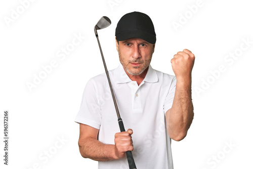 Middle aged golfer man showing fist to camera, aggressive facial expression.