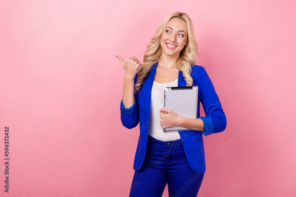 Photo of charming corporate agent girl hold tablet look direct finger empty space isolated on pink color background Photo of charming corporate agent girl hold tablet look direct finger empty space isolated on pink color background
