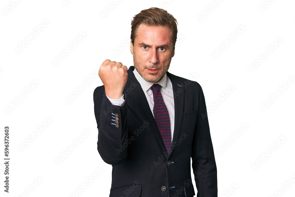 A middle-aged businessman isolated showing fist to camera, aggressive facial expression. A middle-aged businessman isolated showing fist to camera, aggressive facial expression.