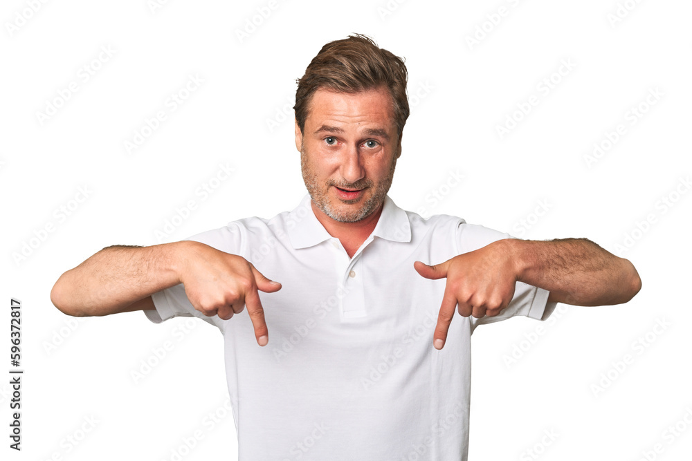 A middle-aged man isolated points down with fingers, positive feeling. A middle-aged man isolated points down with fingers, positive feeling.