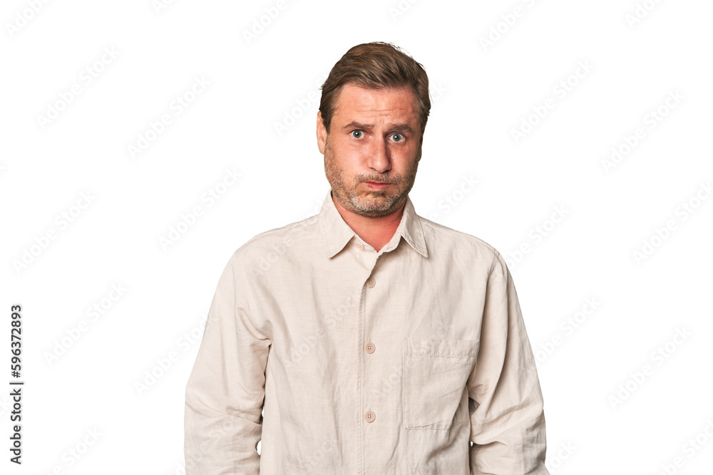 A middle-aged man isolated blows cheeks, has tired expression. Facial expression concept. A middle-aged man isolated blows cheeks, has tired expression. Facial expression concept.