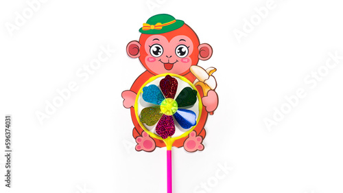 Colorful toy monkey wind turbine isolated on white background.