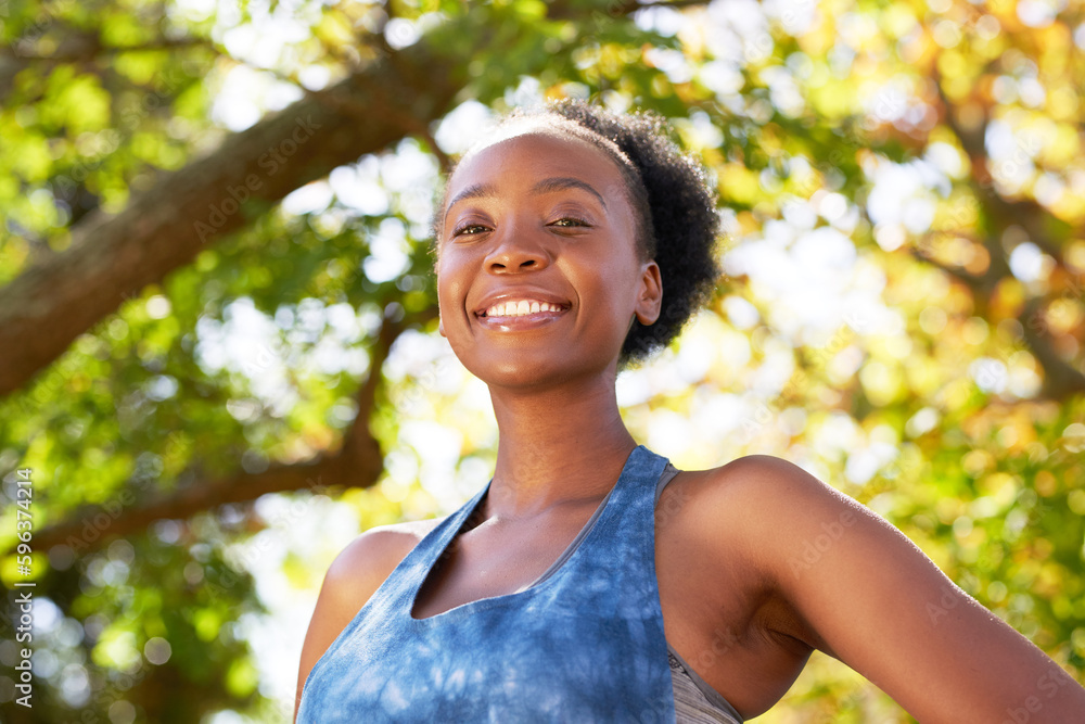 Portrait of young Black woman in fitness wear with trees, park, sunshine Portrait of young Black woman in fitness wear with trees, park, sunshine