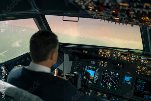 The pilot in the cockpit of the aircraft turbulence during the flight Flight simulator navigation devices