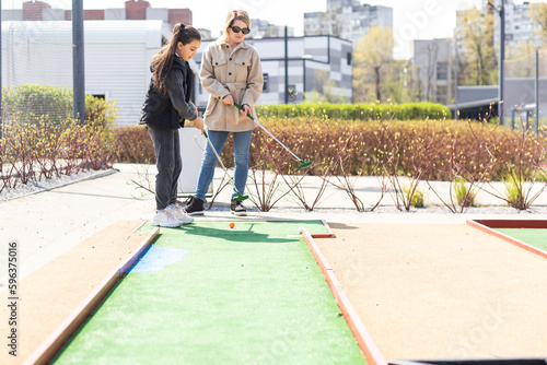 Family Time Playing Mini-Golf In The Summer photo