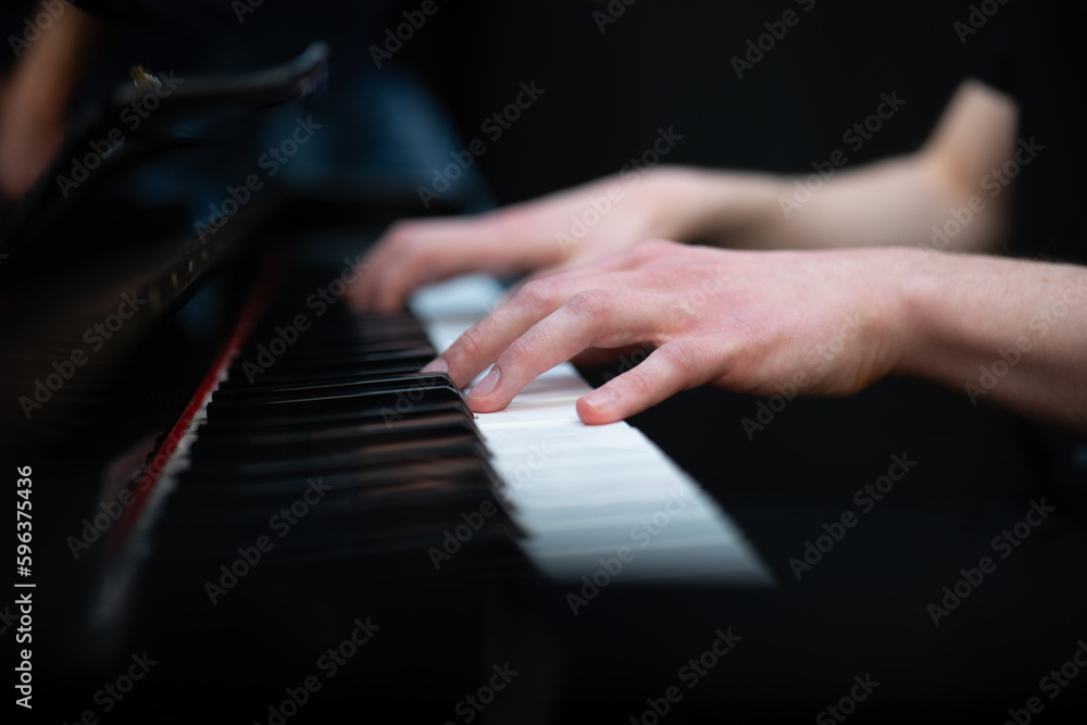 Fototapeta premium hands of a person playing the piano