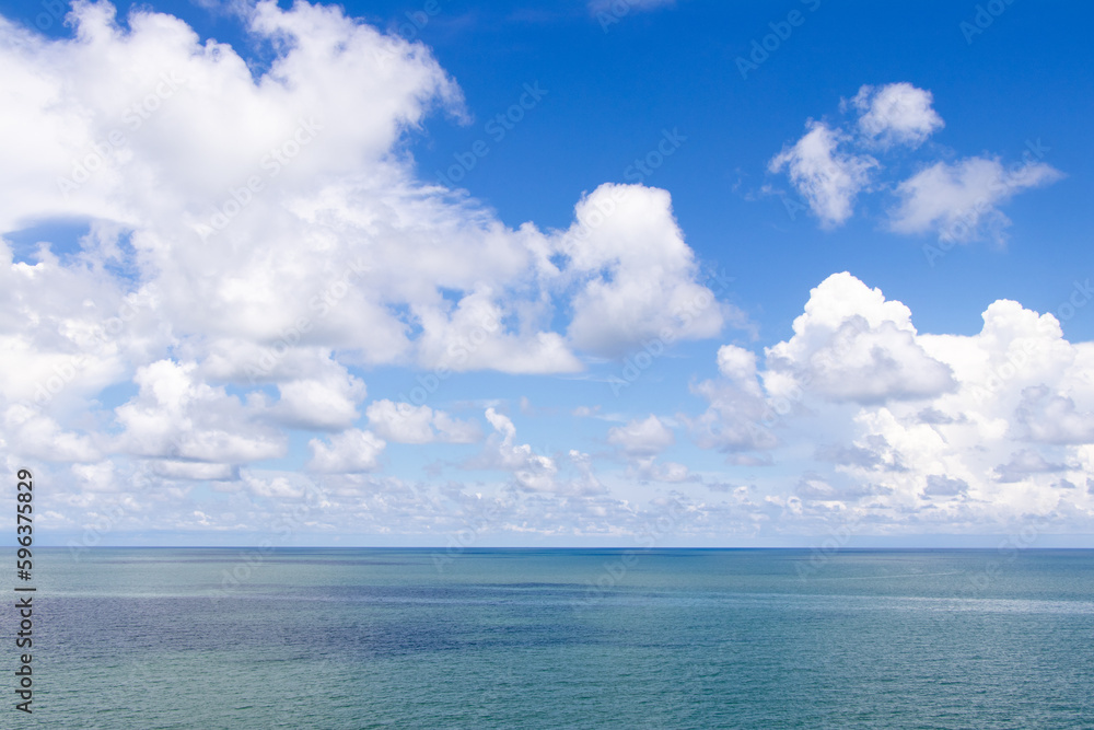 Beautiful calm turquoise color sea and blue sky with white color cloud background