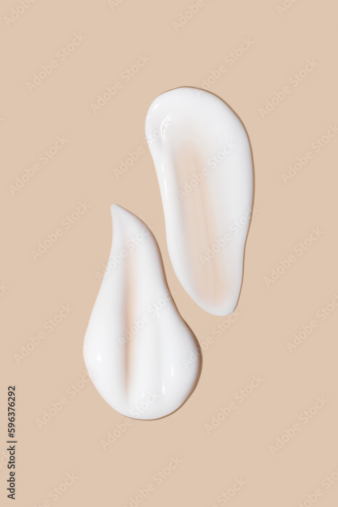 a set of strokes of white cream on a beige background. a set of strokes of white cream on a beige background.
