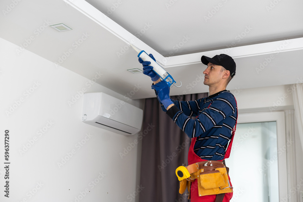 Construction worker ceiling work. working on repairs Construction worker ceiling work. working on repairs