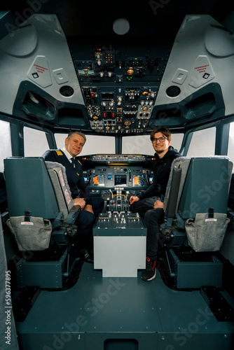 airplane cockpit pilot and young student boy smiling after training on flight simulator entertainment concept