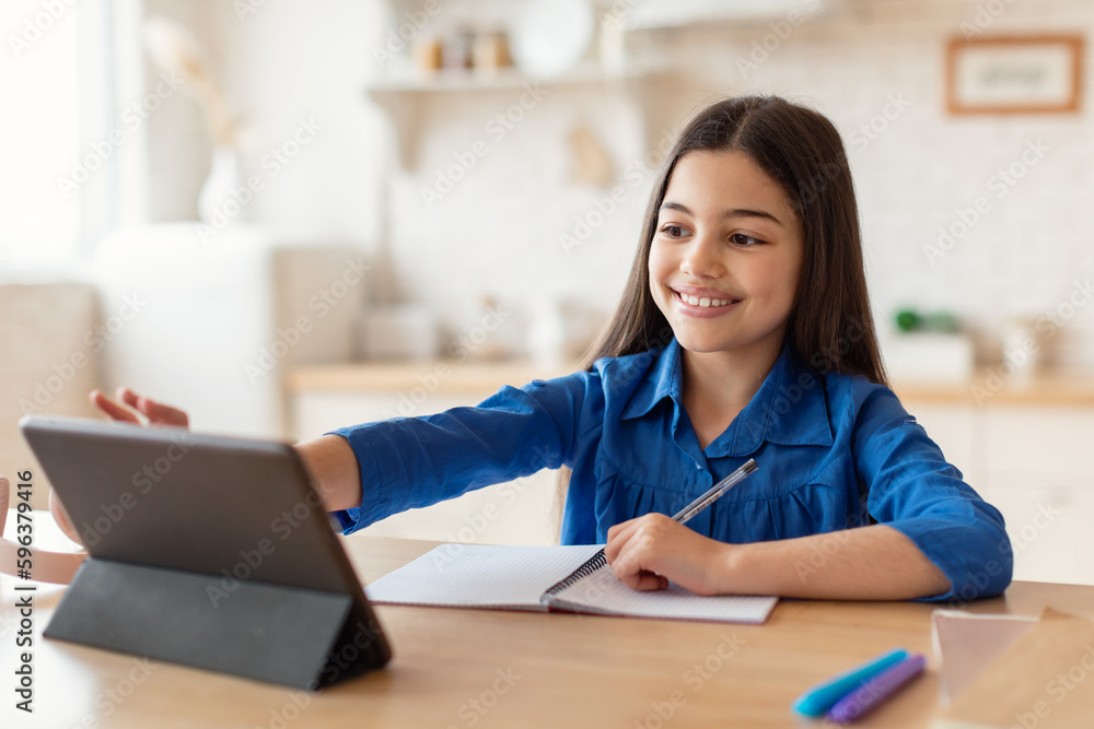 Happy Schoolgirl Using Digital Tablet Doing Homework Online At Home Happy Schoolgirl Using Digital Tablet Doing Homework Online At Home