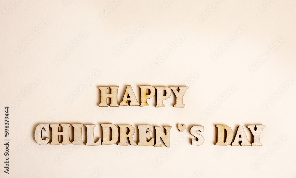 happy childrens day inscription composed from wooden eco letters isolated on t shirt kid child sleeves.collar red as smile meaning joy of celebration. june 1st kids day