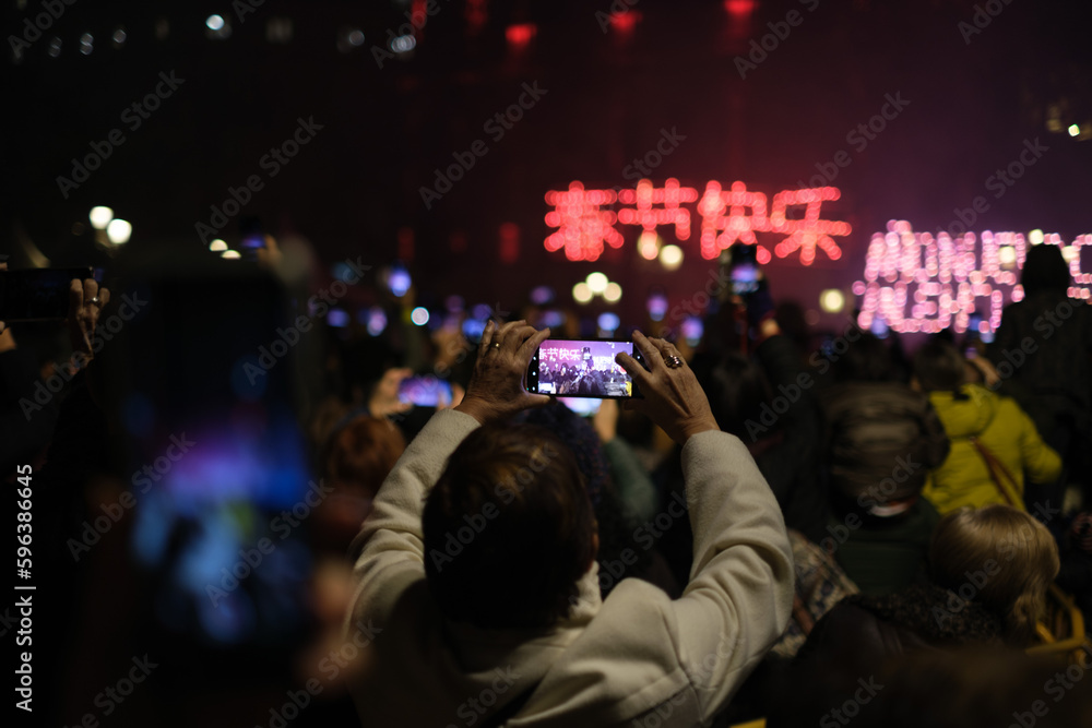 Mobile phone filming the Chinese New Year celebration in vertical mode 