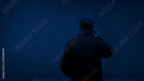 Man Talks On Phone Outdoors At Night photo