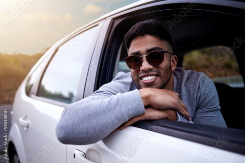 Create your story. Shot of a handsome young man enjoying an adventurous ride in a car.