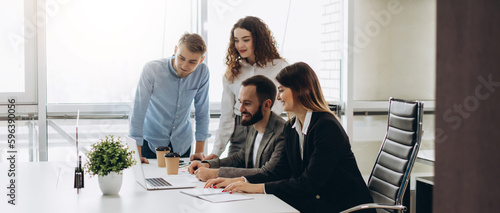 Young coworkers. Young modern colleagues in smart casual wear working while spending time in the office
