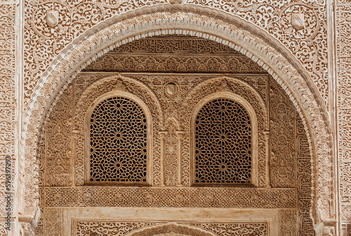  Marble capitals and stucco decoration of the portico in Patio del Cuarto Dorado in Mexuar in Comares Palace Alhambra, Andalusia, Spain. Magic breathtaking carved decoration in orient style.