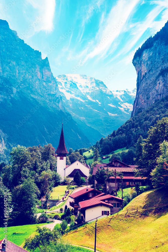The Incredible picturesque landscape in Lauterbrunnen with canyon, church and famous Staubbach waterfall in the Swiss Alps, Switzerland. Amazing places.