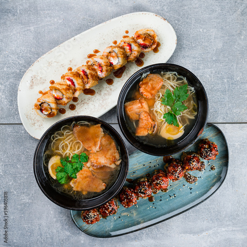 Lunch set of Ramen soup with noodles, chicken and beef and assorted sushi roll sets.