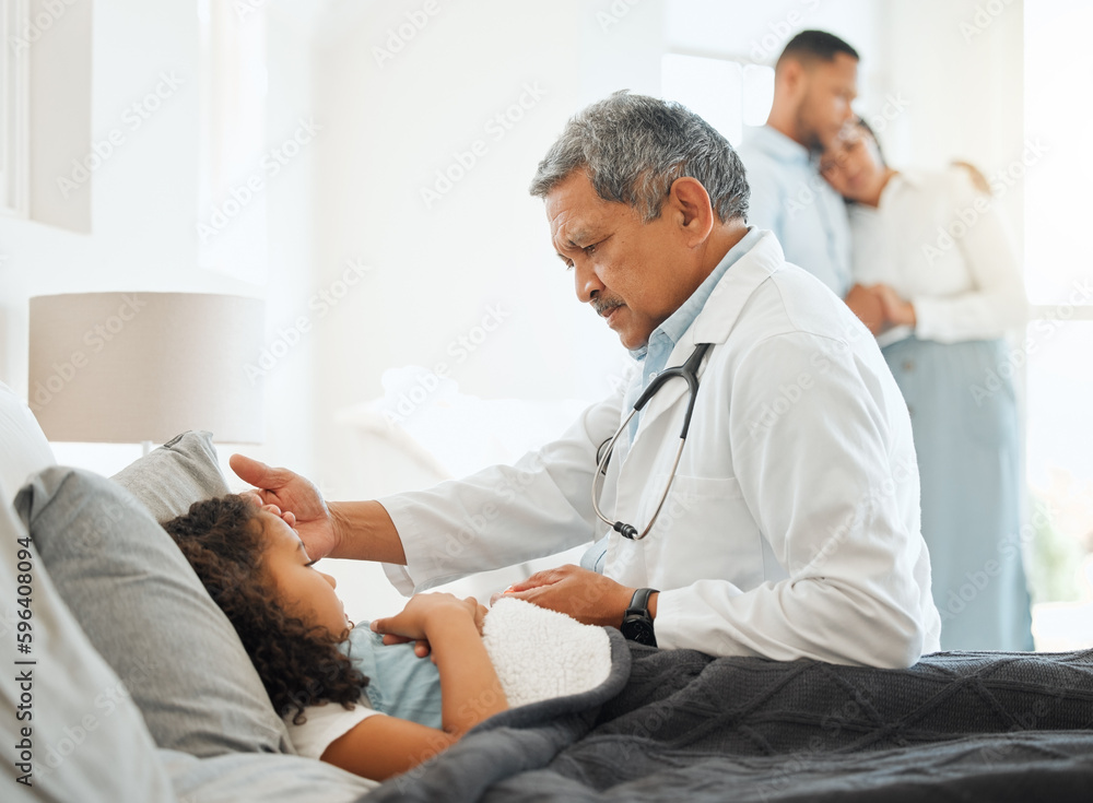 Obraz premium Lets figure out the problem. Shot of an unrecognizable doctor checking a sick little girls temperature at home.