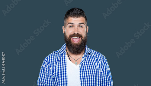 happy amazed bearded man wear checkered shirt on grey background