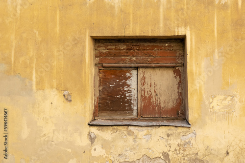 Bilde på lerret Boarded up window in an old dilapidated stone wall