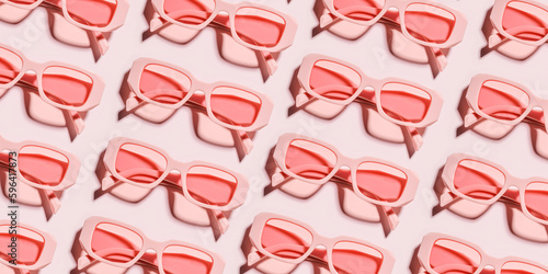 Minimal pattern from pink eyeglasses on rose background, visual trends summer concept. Top view aesthetic photo, colored sunglasses as creative geometric pattern, monochrome flat lay glasses