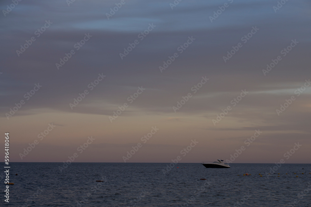 Lonely boat at the sea during the sunset. 