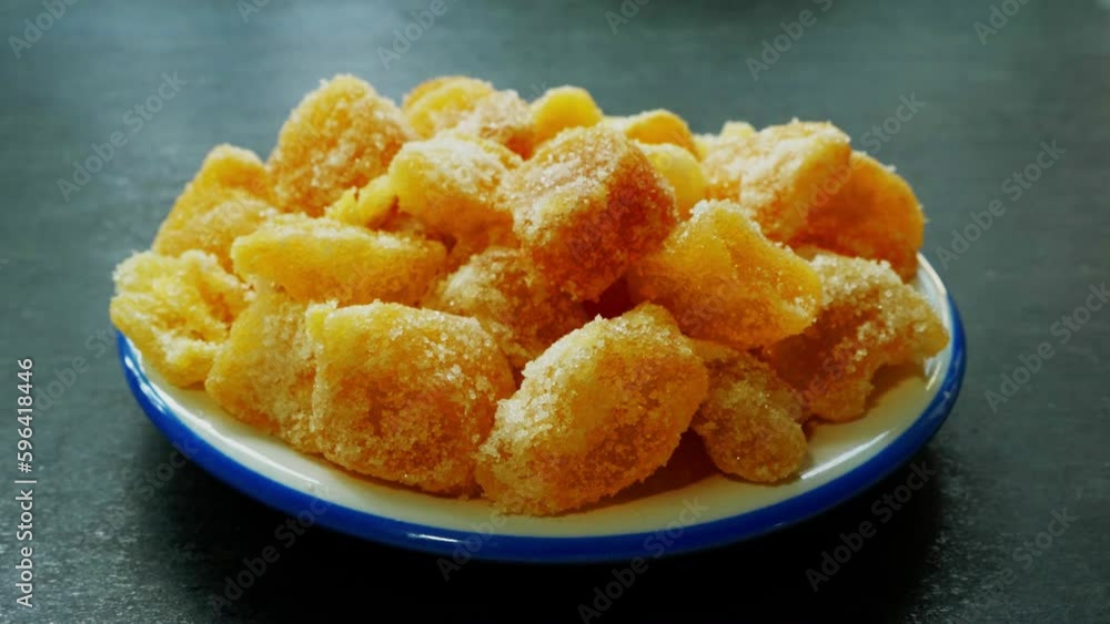 Closeup circular dolly shot of sugar coated, crystallised ginger pieces on a small plate. Closeup circular dolly shot of sugar coated, crystallised ginger pieces on a small plate.