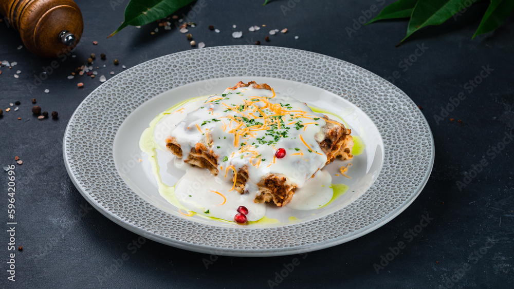 Italian lasagna with bechamel sauce, bolognese and greens. Italian lasagna with bechamel sauce, bolognese and greens.