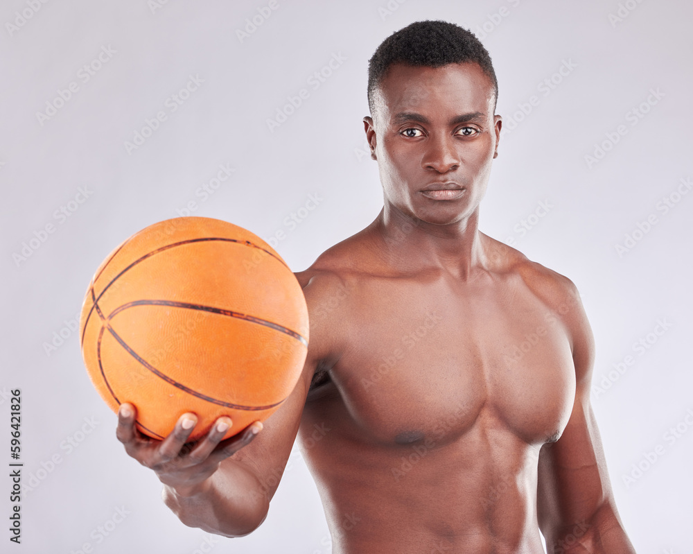 Ill show you how to shoot hoops. Studio portrait of a muscular young man posing with a basketball against a grey background.