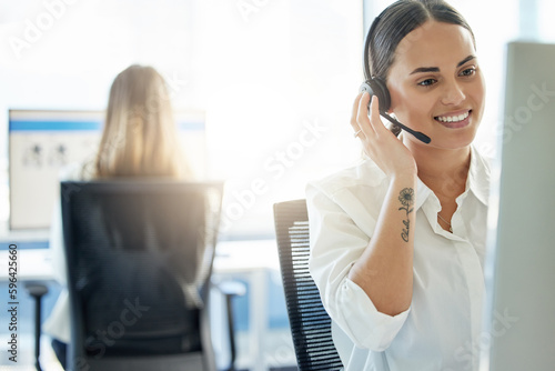 Call our customer care line. Shot of a young woman wearing a headset while working in a call center.