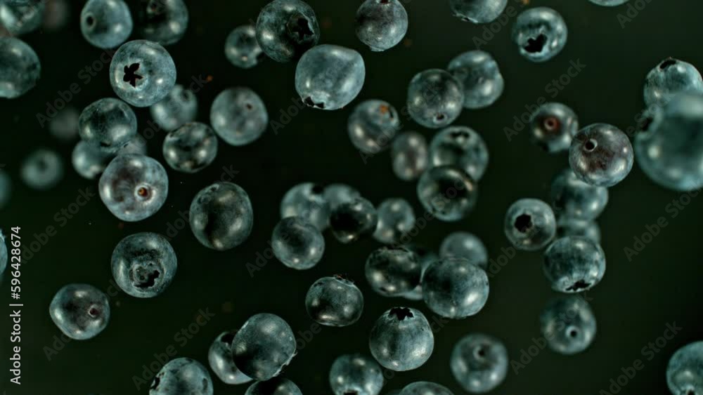 Super slow motion of rotating blueberries in the air, top view. Filmed on high speed cinema camera, 1000 fps. Speed ramp effect. Super slow motion of rotating blueberries in the air, top view. Filmed on high speed cinema camera, 1000 fps. Speed ramp effect.